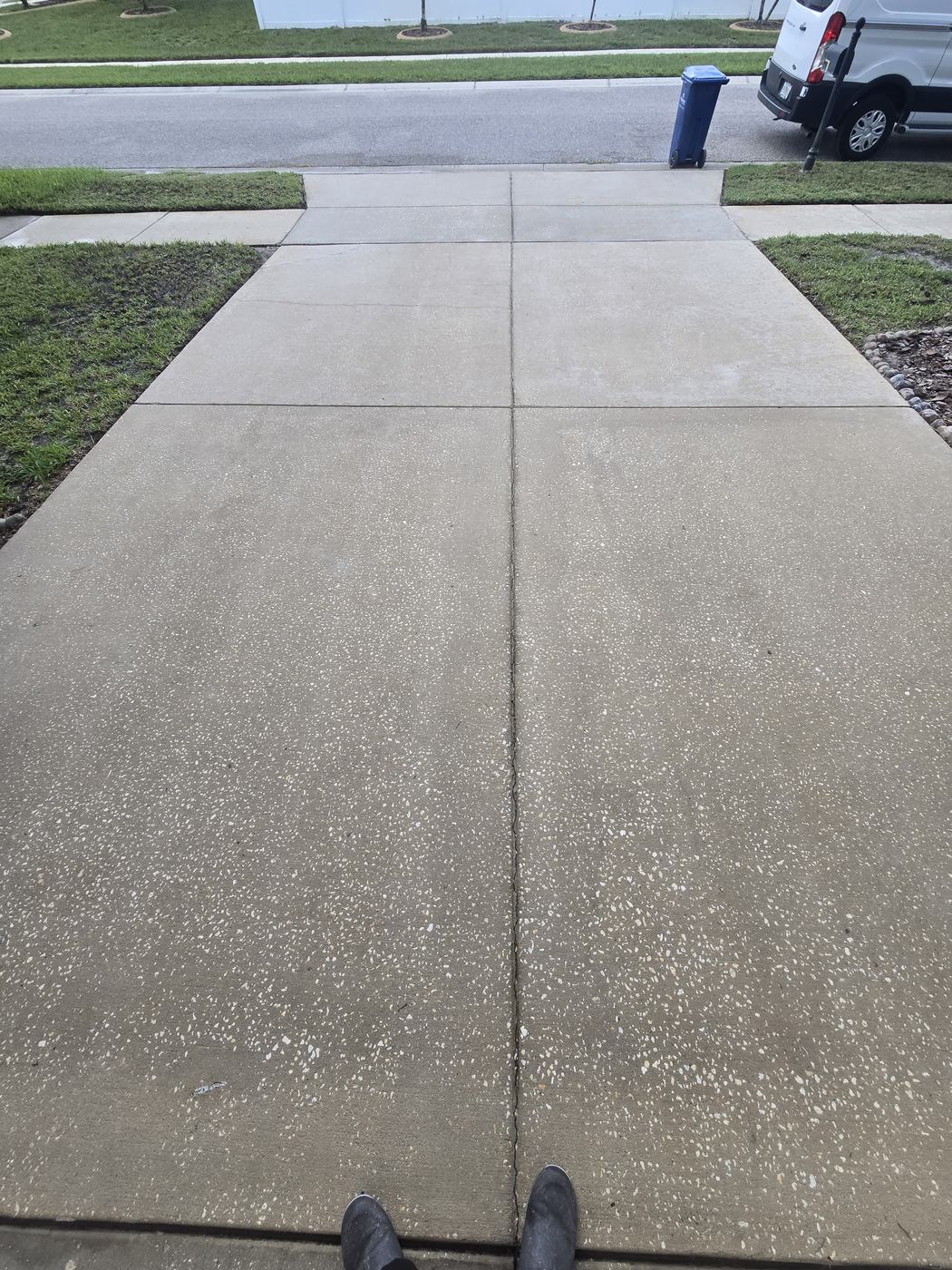 Tampa concrete driveway after professional pressure cleaning, restored to a clean, even finish