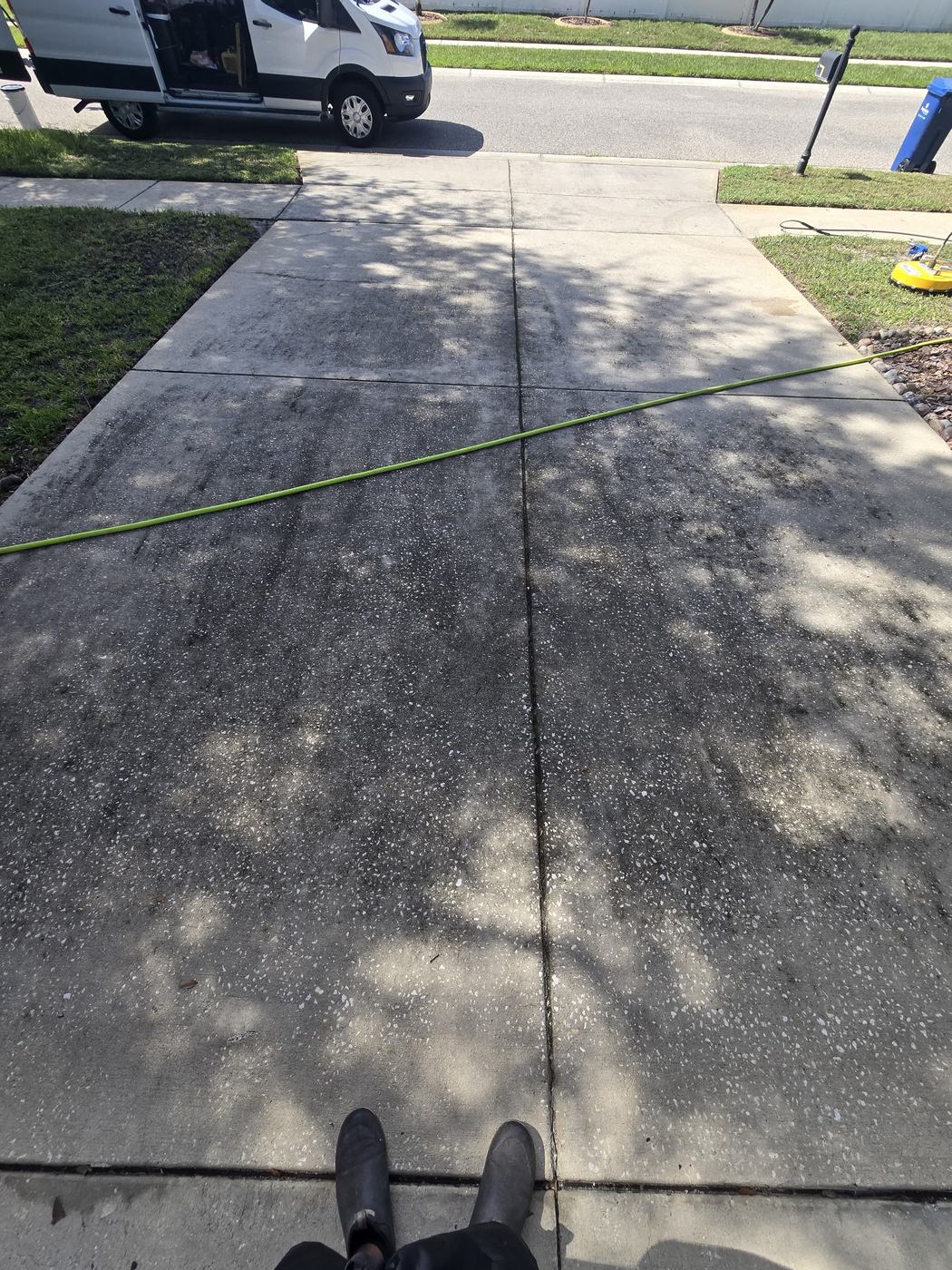 Tampa concrete driveway darkened with dirt and organic staining before pressure cleaning