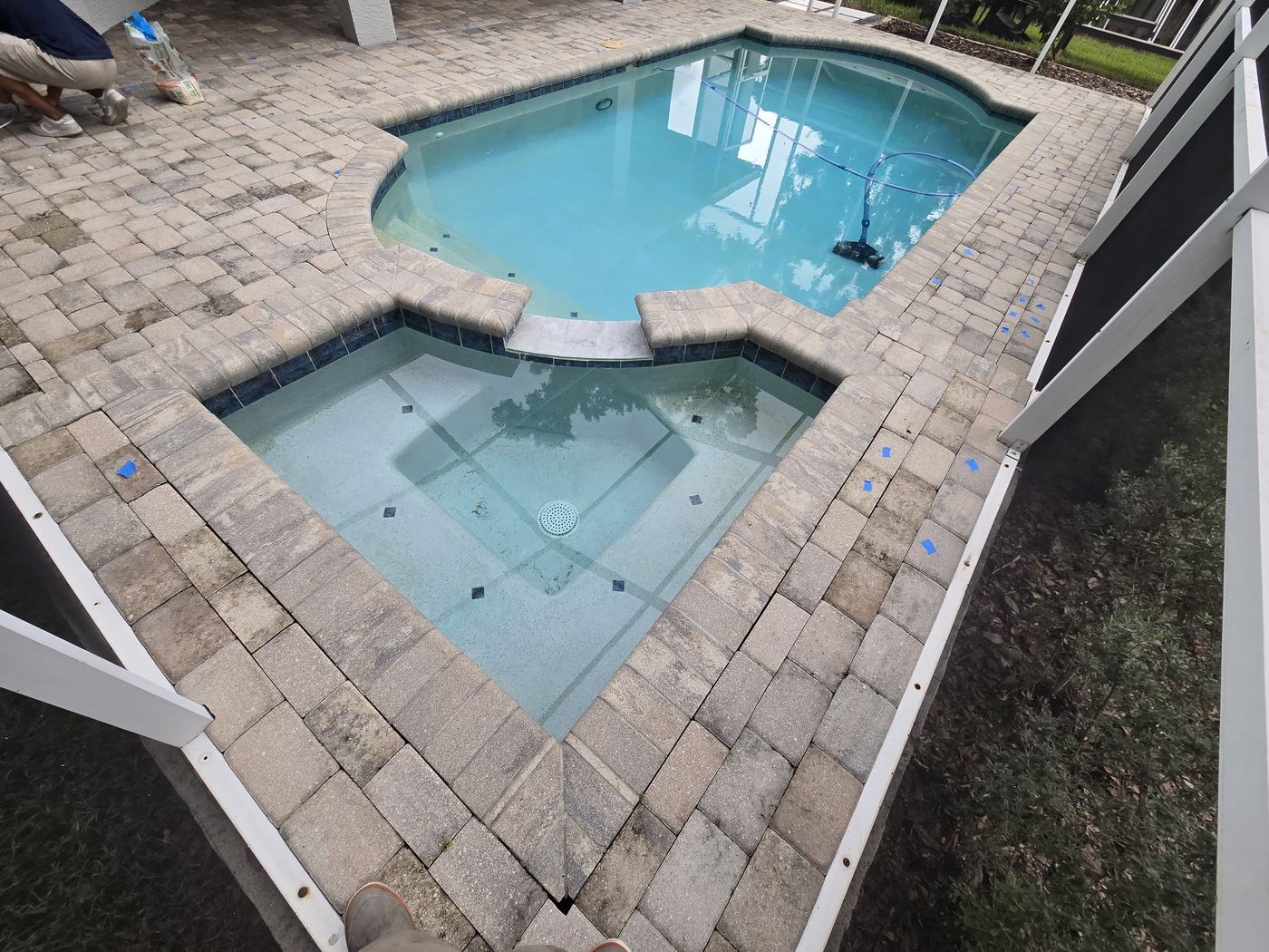 Faded pool and spa deck pavers in Tampa before paver sealing